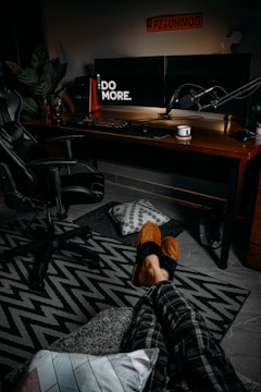 Cozy streaming studio setup with multiple monitors and gaming chair.