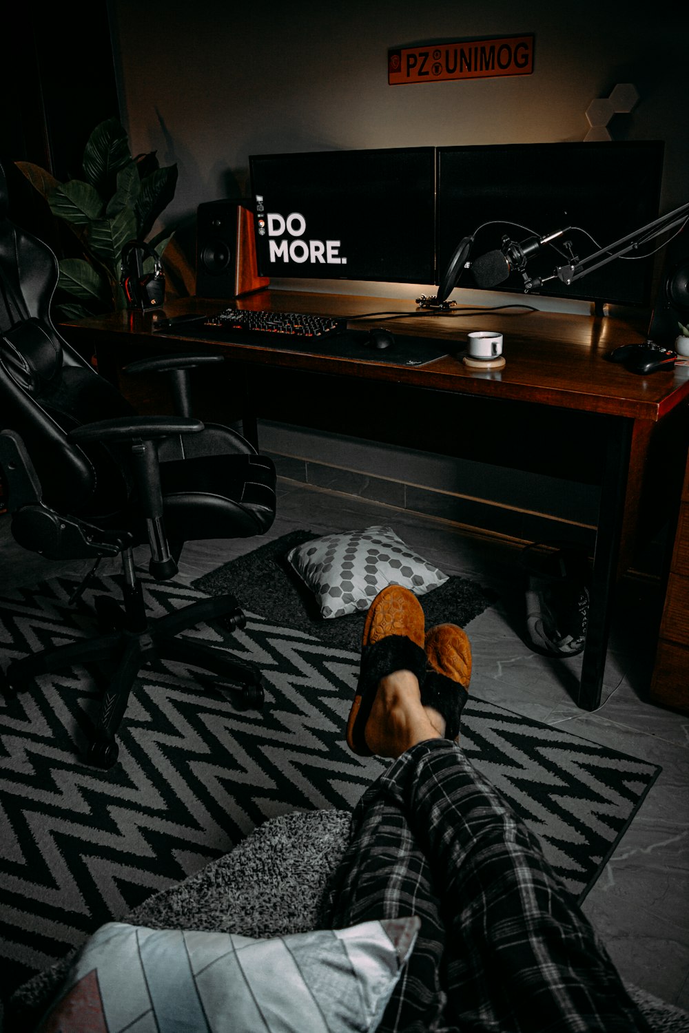 person in black and white plaid pants sitting on black office rolling chair