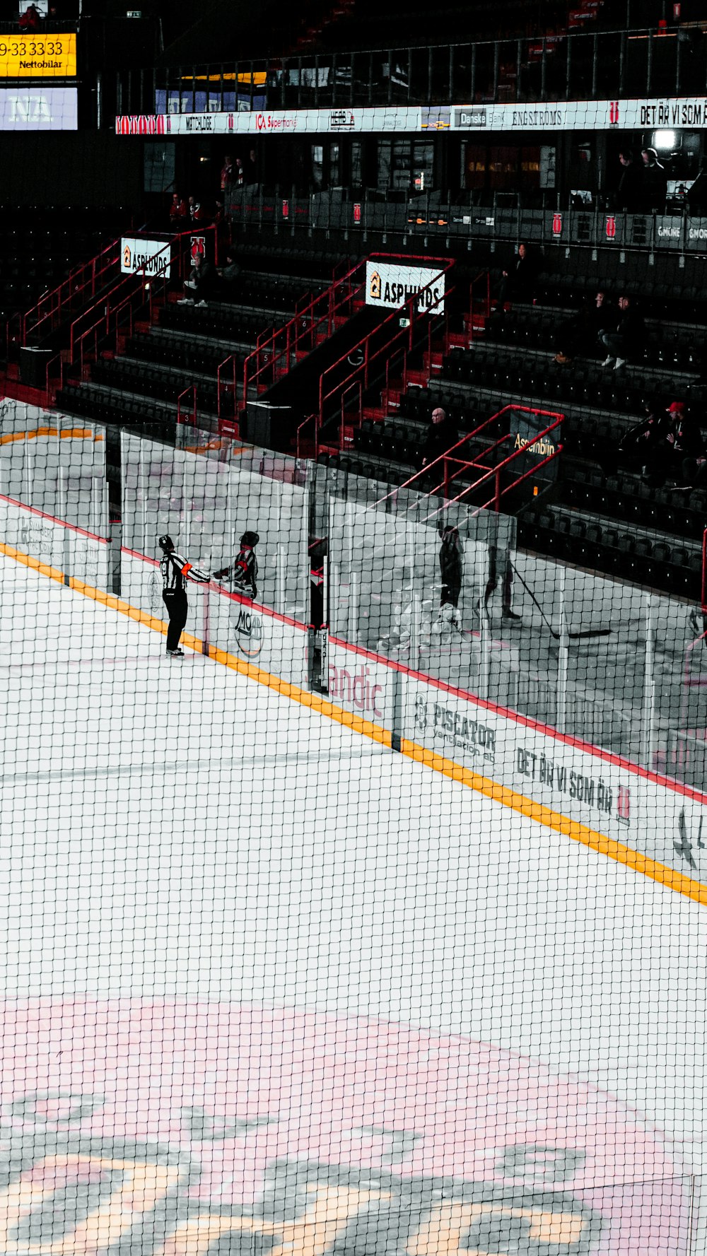 man in black shirt and pants playing ice hockey