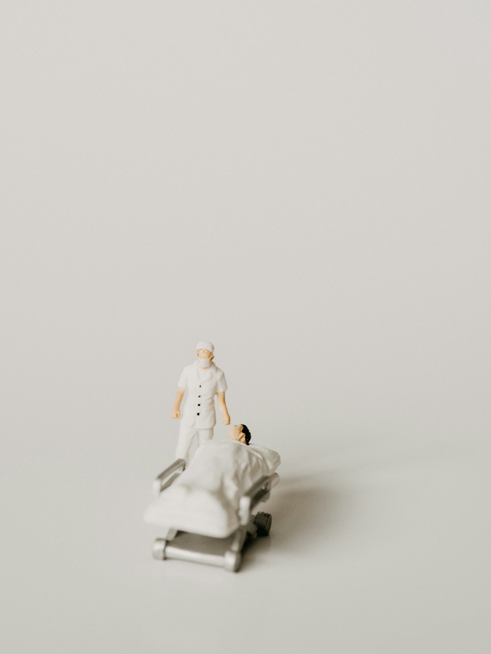 white ceramic figurine on white surface