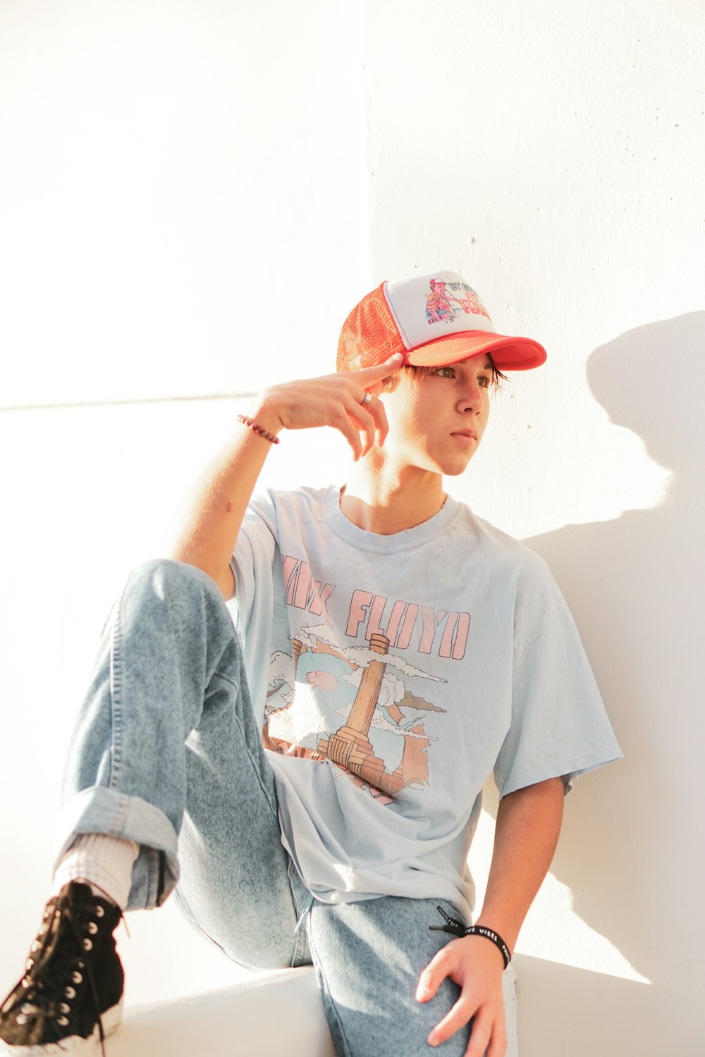 boy in white and red crew neck t-shirt and red cap