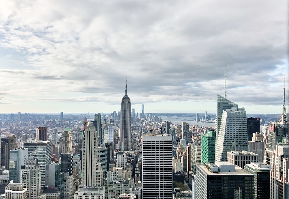 city skyline under white clouds during daytime