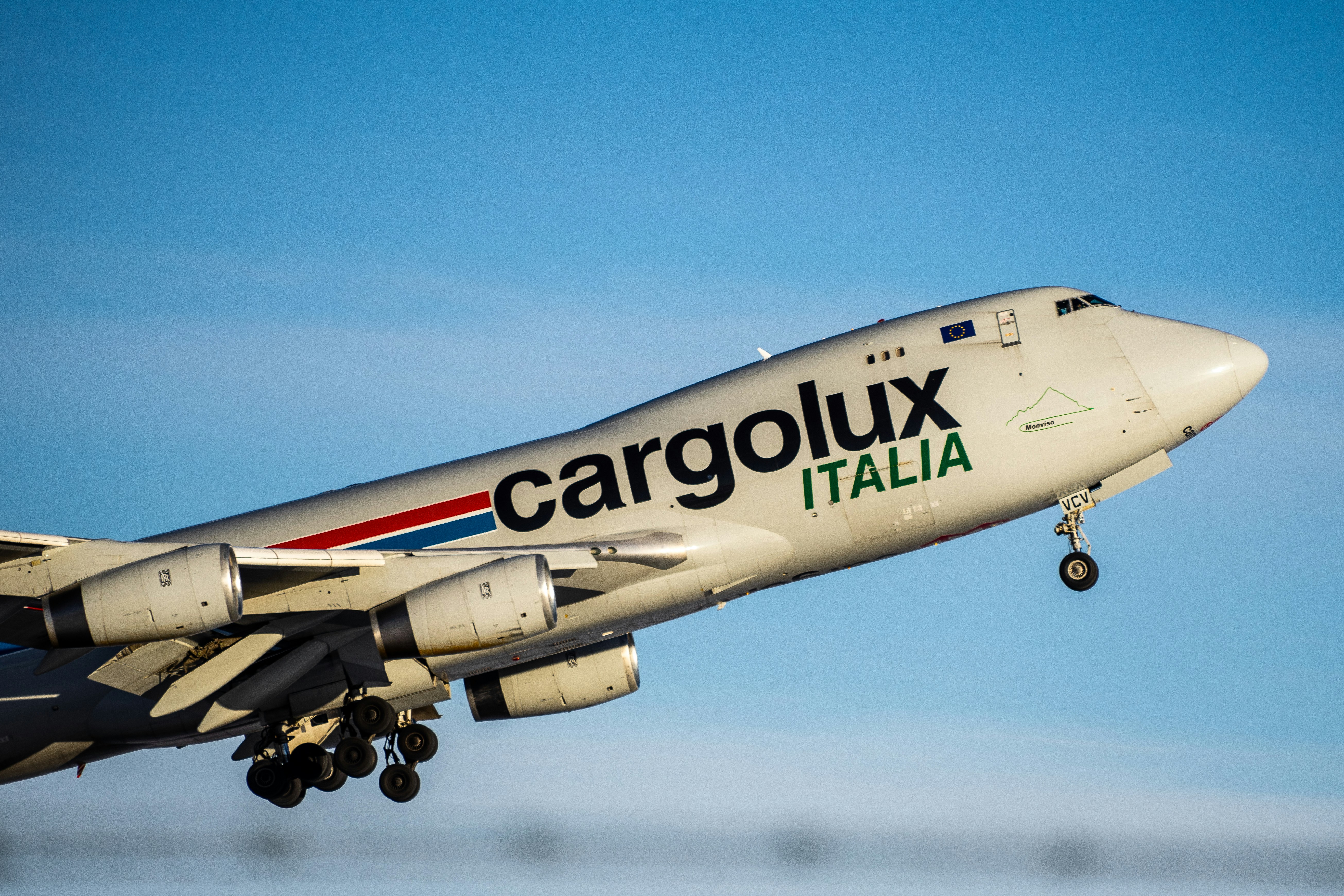 white and blue airplane under blue sky during daytime, Cargolux 747-4 powering out of Calgary International.