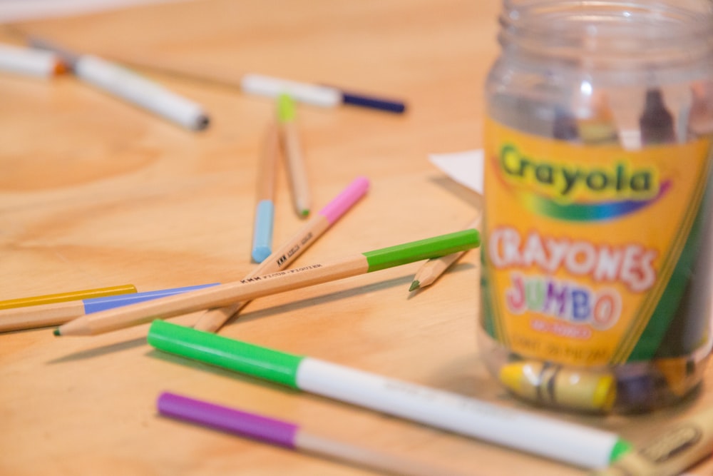 UNKs lemonade bottle beside green and purple pen