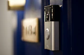 High-resolution photo showcasing a video door phone in use at a family's home entrance.