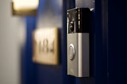 High-resolution photo showcasing a video door phone in use at a family's home entrance.