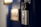 A smart video doorbell is mounted on a deep blue door with a blurred out number plate in the background.