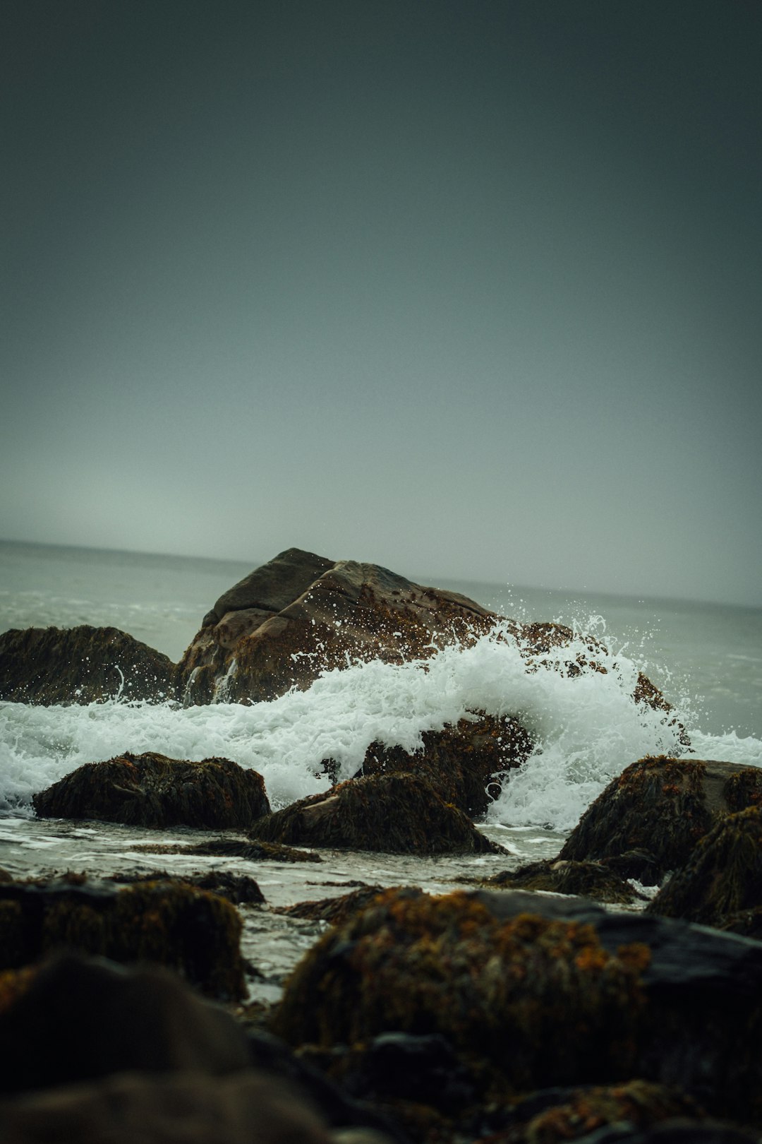 brown rock formation on sea water during daytime