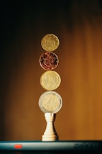 gold round coins on brown wooden surface
