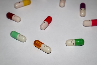 Close-up of colorful capsules arranged on a white surface.