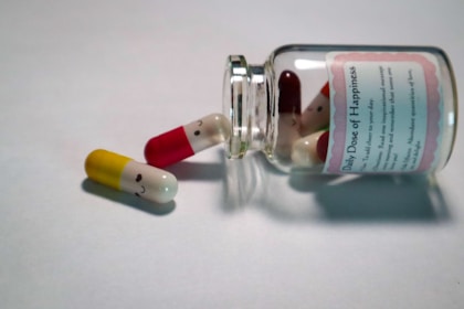 white and red medication labeled bottle