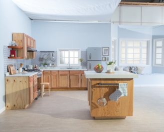 brown wooden kitchen cabinet near white wall