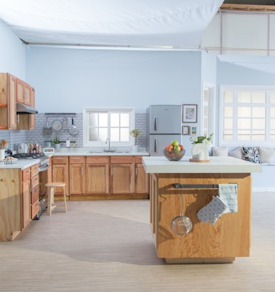 brown wooden kitchen cabinet near white wall