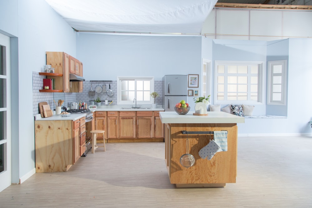 brown wooden kitchen cabinet near white wall