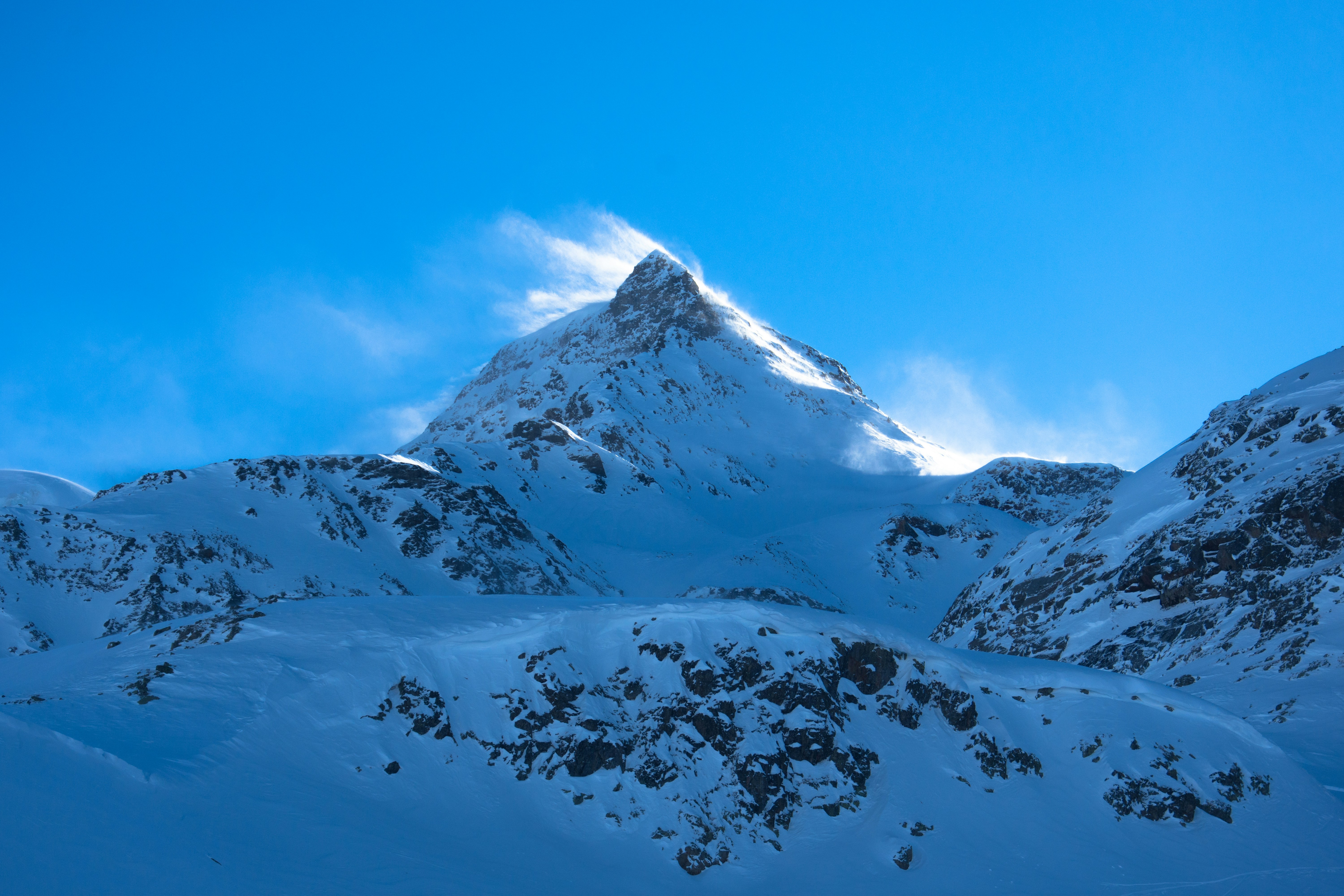 snow covered mountain under blue sky during daytime