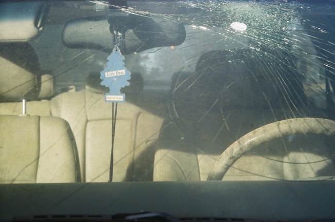 Before and after images showing a cracked windshield transformed to flawless clarity by Clearwater Auto Glass.