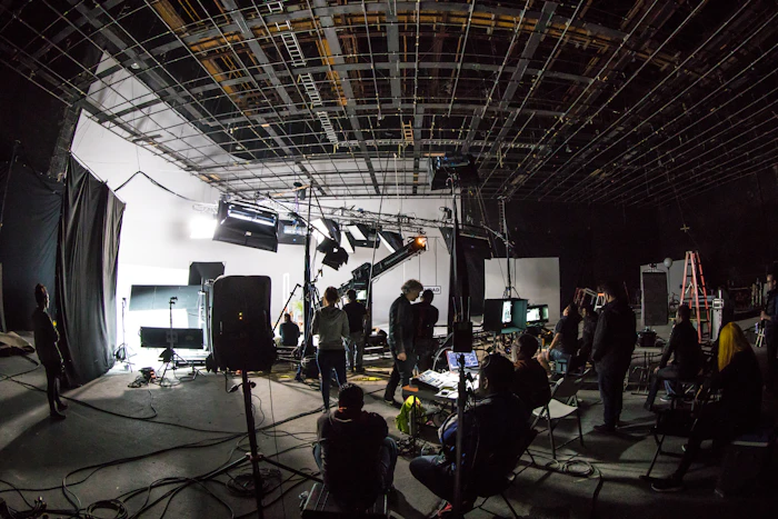 Film crew working on a soundstage with professional production gear