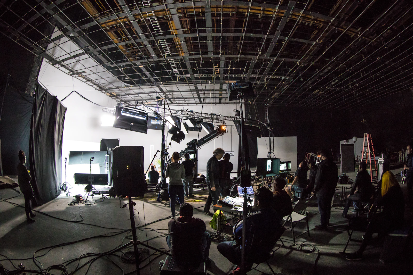 Crew working around a camera and lighting setup