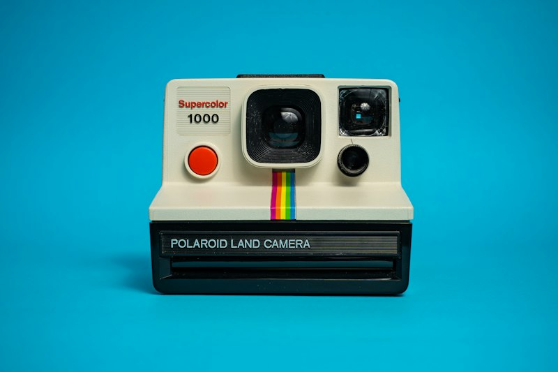 Small white and black polaroid-style instant camera