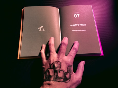 person holding a book with a heart