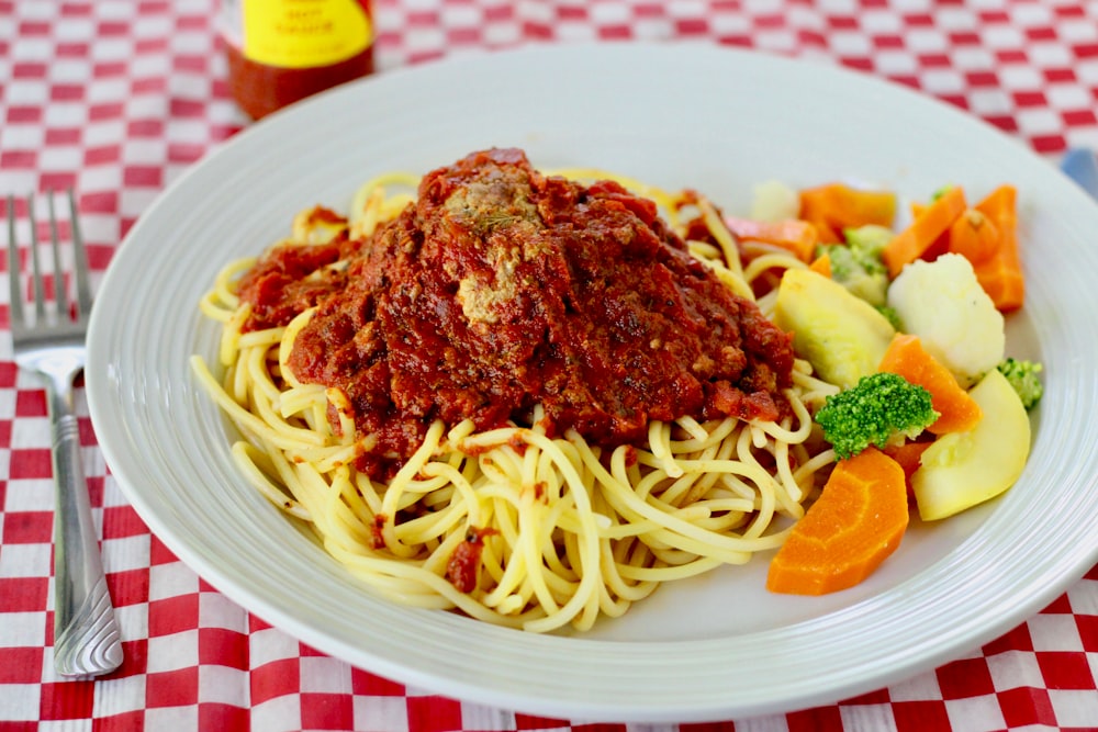 pasta with sauce on white ceramic plate