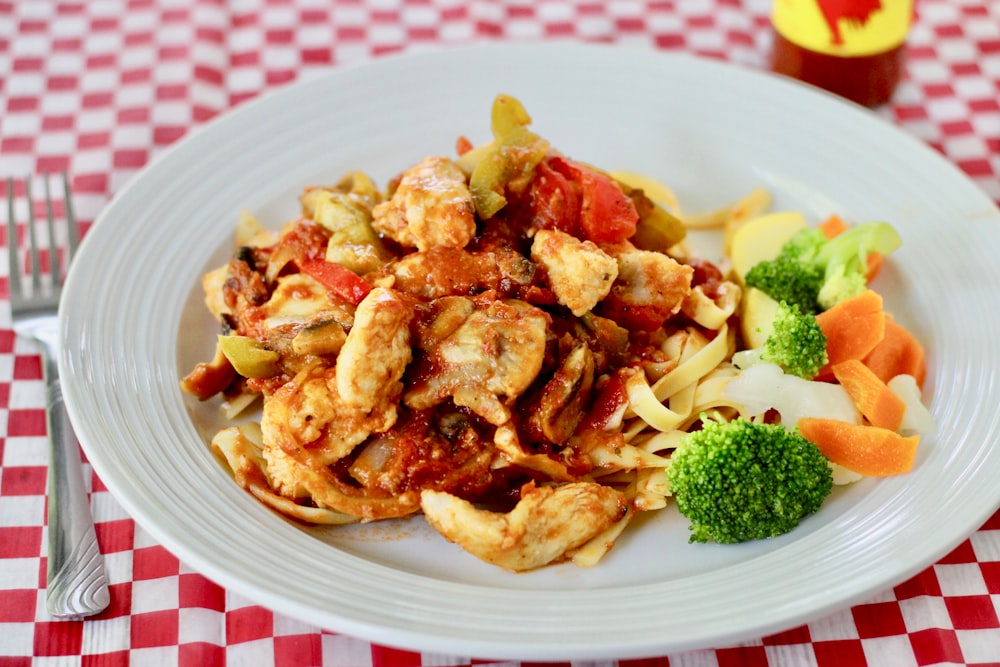 pasta with broccoli on white ceramic plate