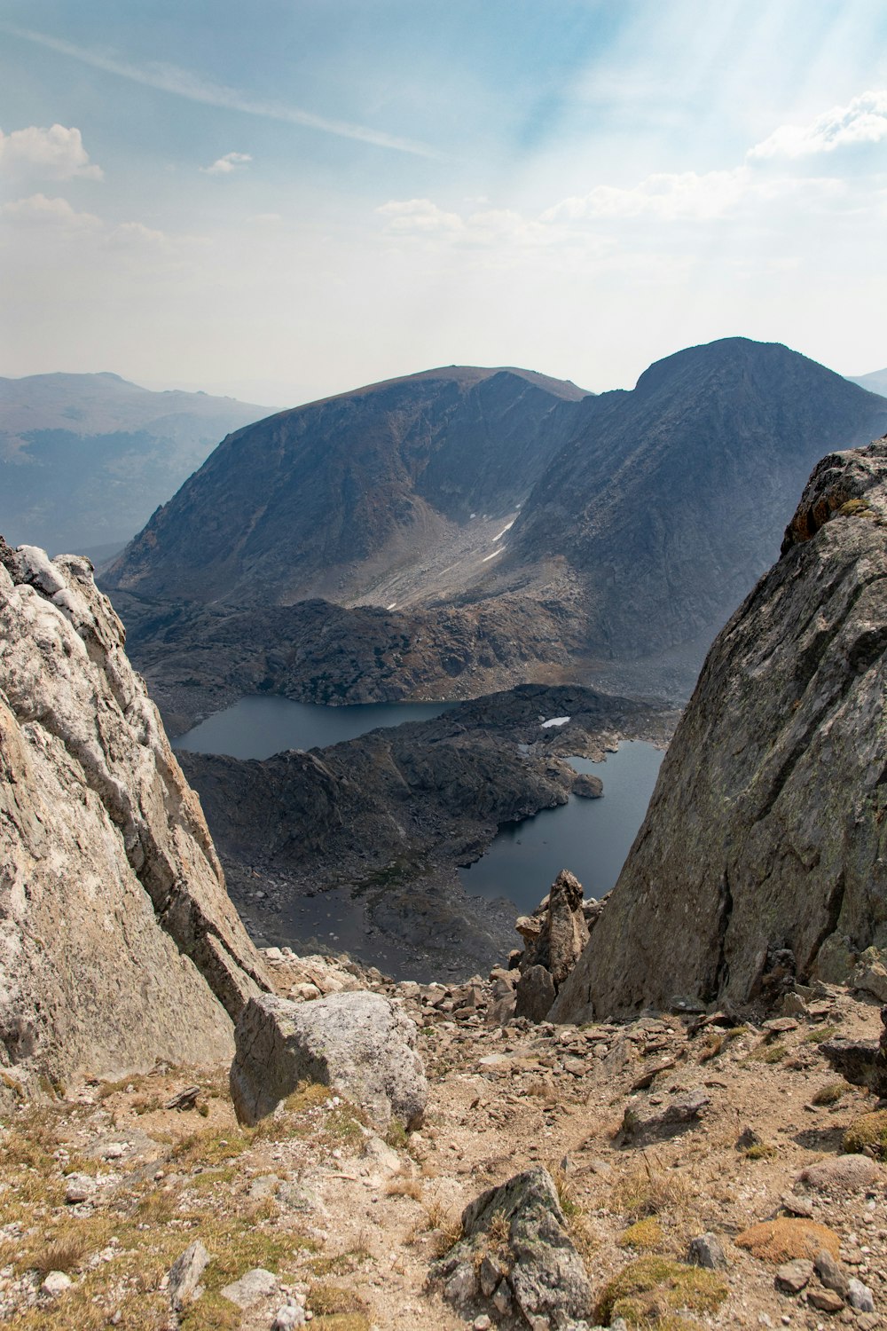 brown rocky mountain near lake during daytime