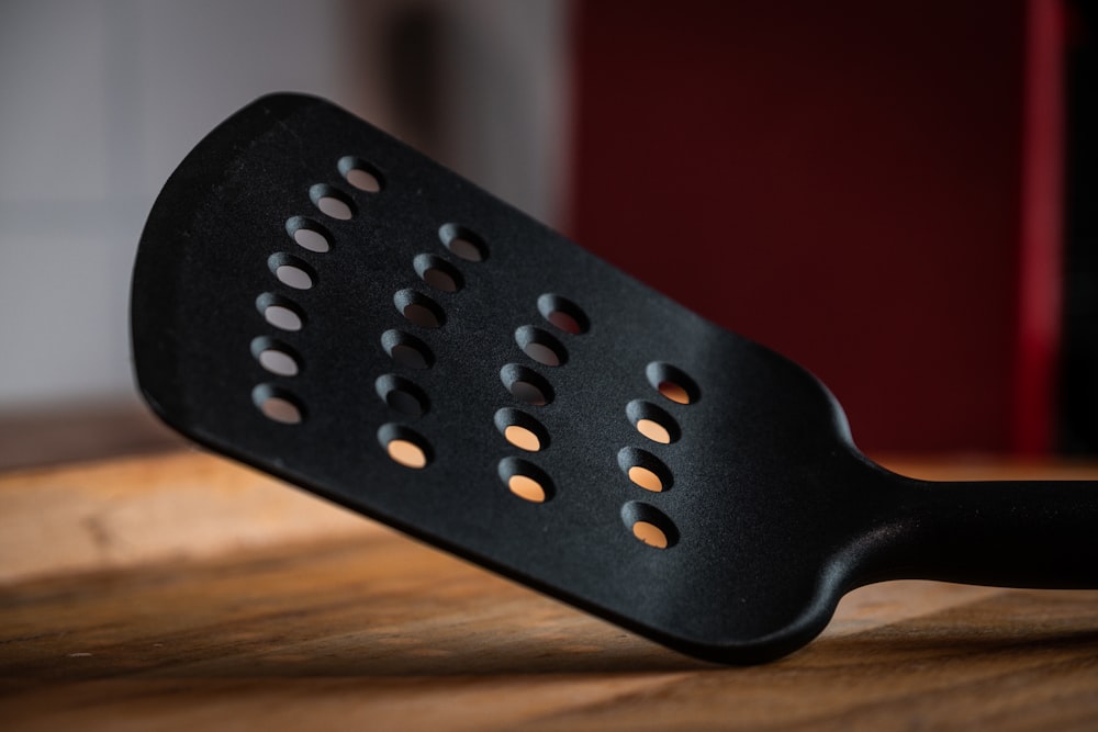 black plastic chair on brown wooden table