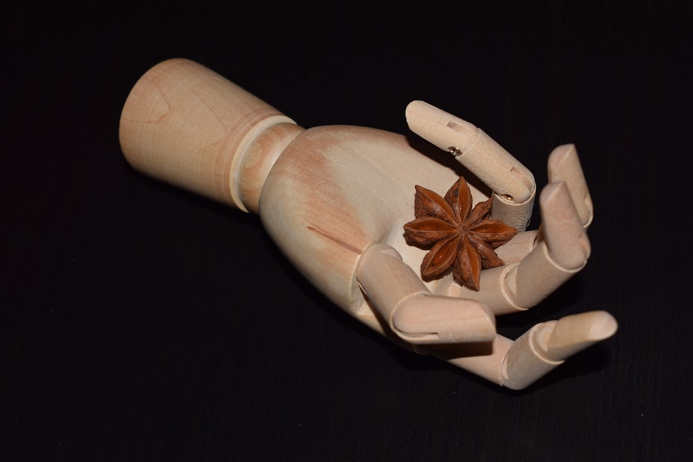 a wooden doll with a star on it's hand