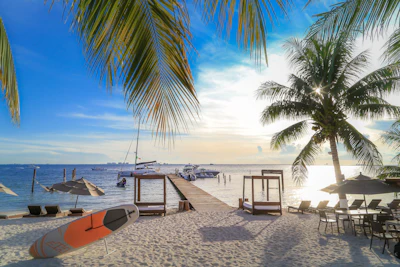 Boats and sunshades on the shallow turquoise water at Playa Norte, Isla Mujeres