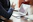 A professional consultant discussing strategy with an international client over a laptop.