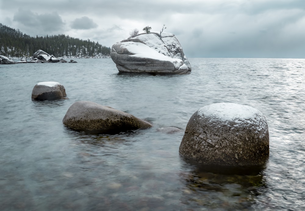 gray rock on body of water during daytime