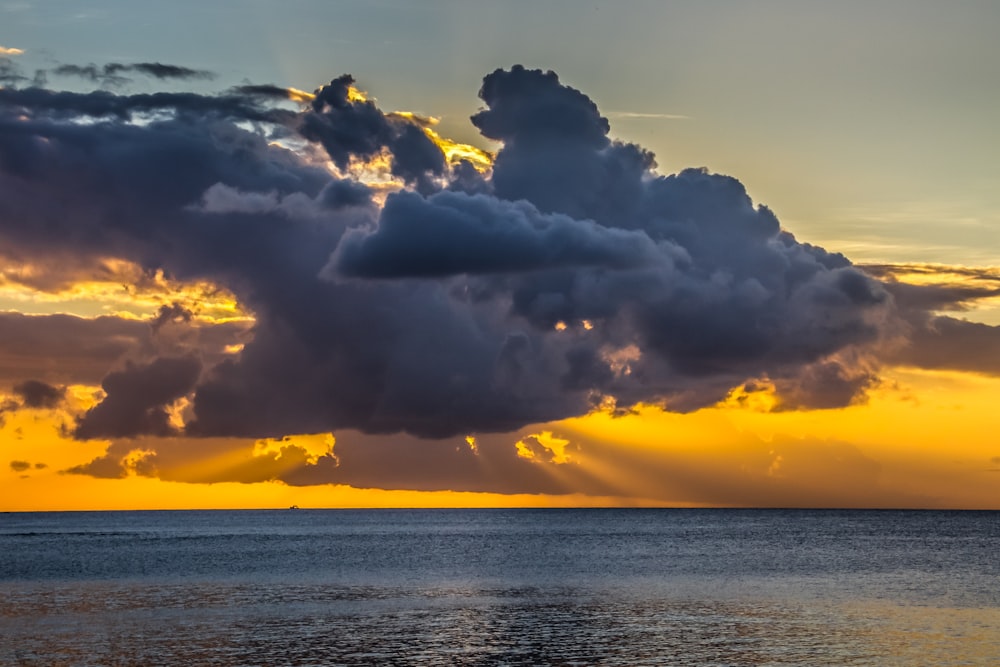 sea under white clouds during sunset