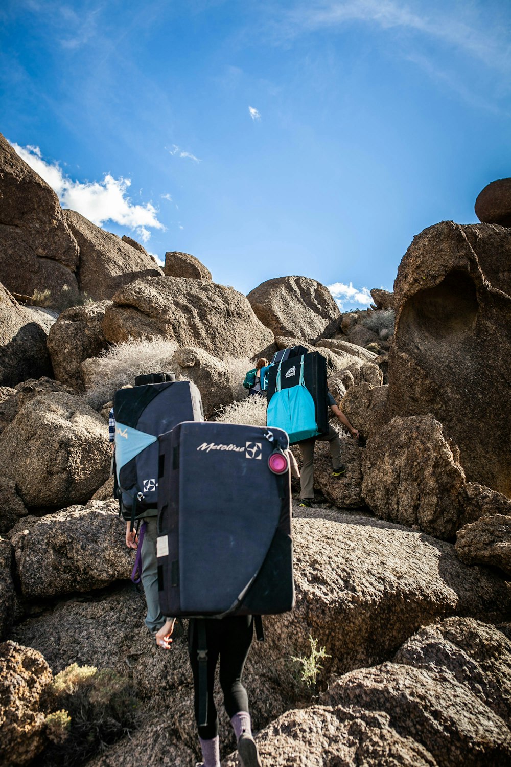 blue and black box on rocky mountain under blue sky during daytime