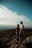 A couple standing at a love point, surrounded by beautiful scenery.