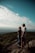 A couple standing at a love point, surrounded by beautiful scenery.