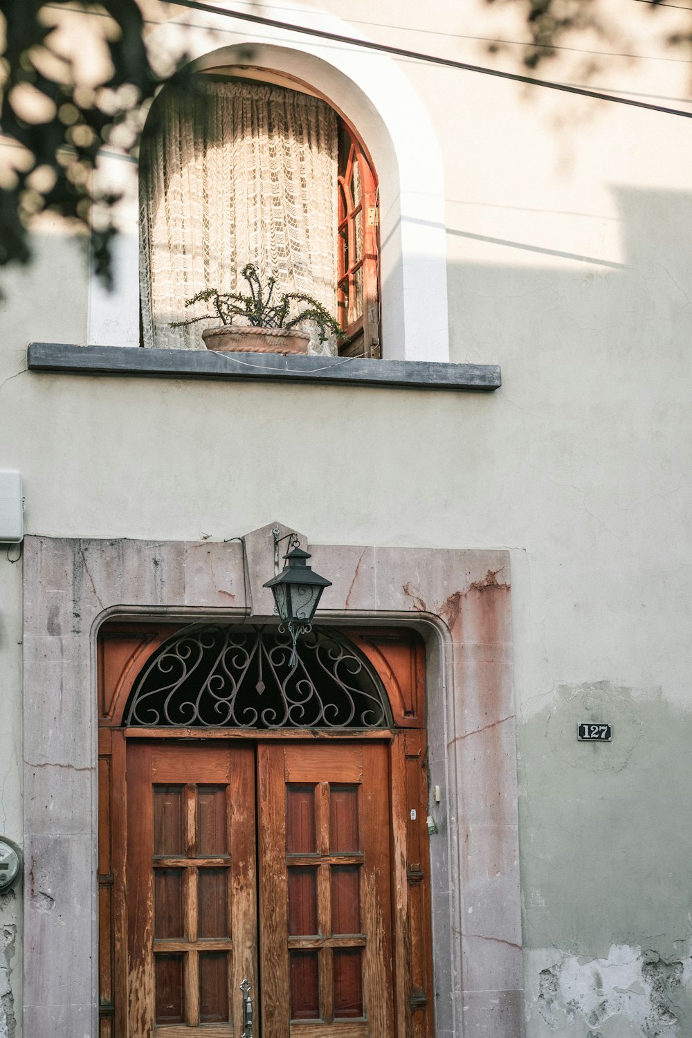 brown wooden door on white concrete building