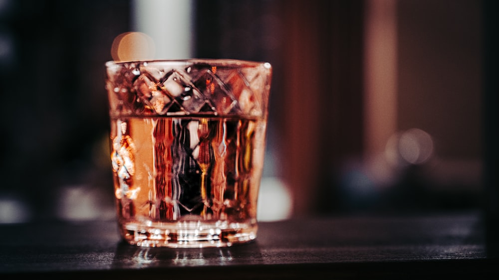 clear drinking glass on black table