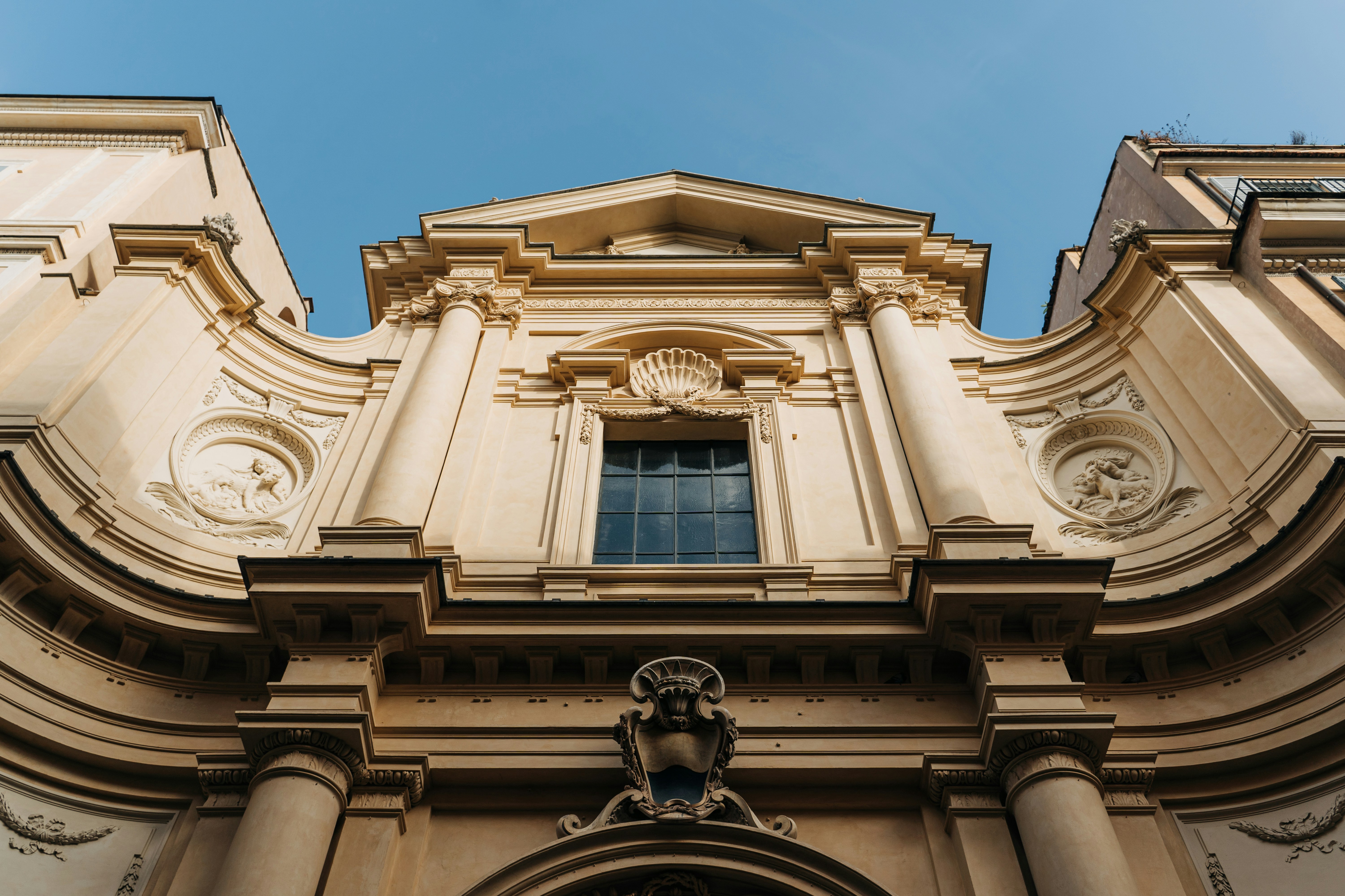 low angle photography of beige concrete building, A church in via Giulia in Rome, Italy. 