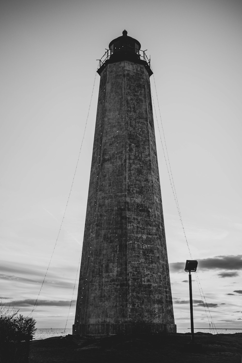 grayscale photo of concrete tower