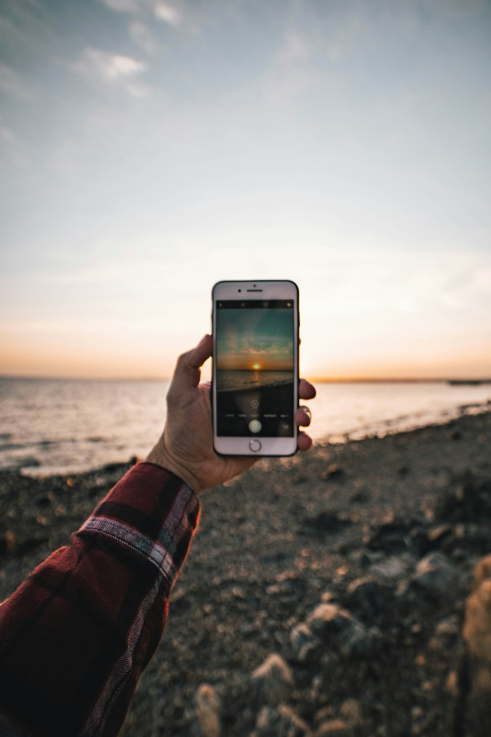 person holding silver iphone 6 taking photo of sea during daytime