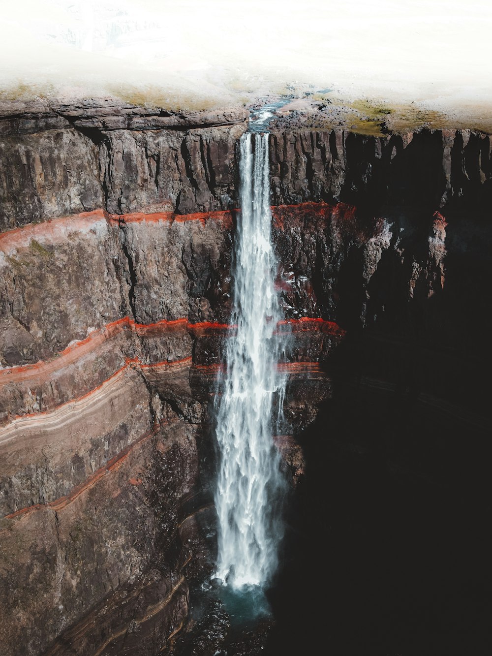 water falling from brown rock