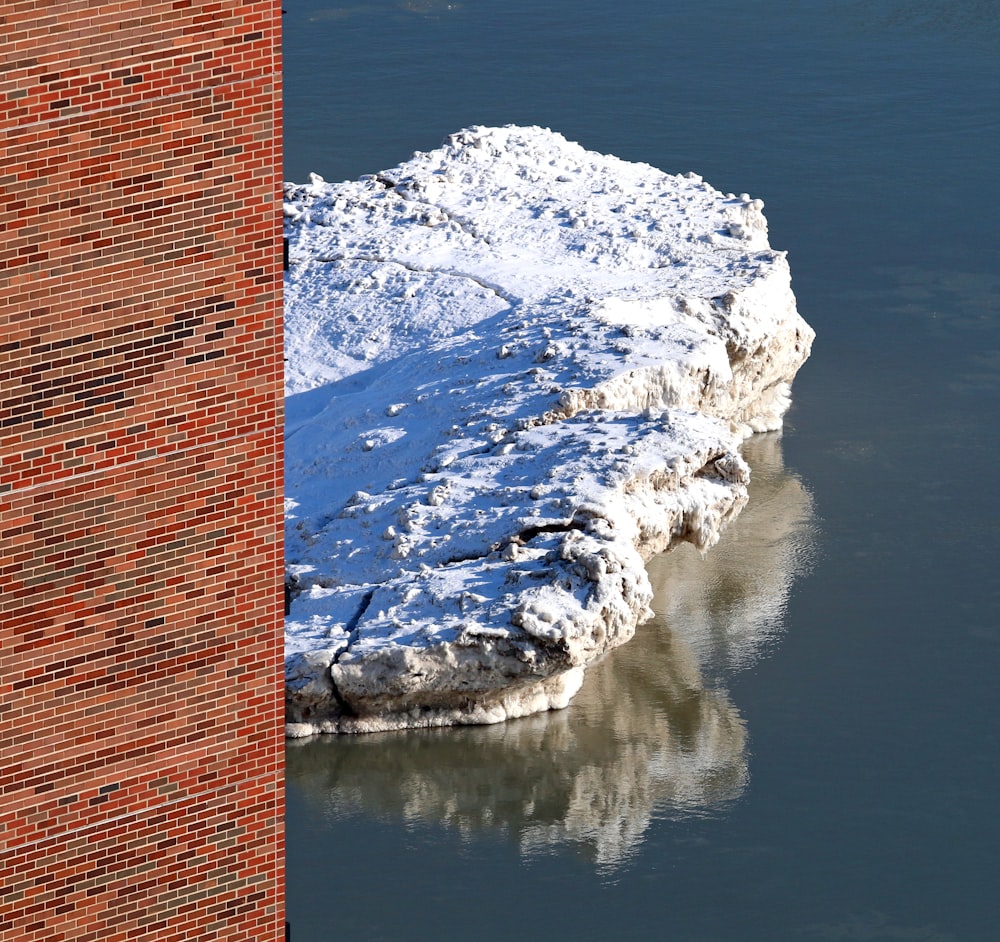 brown brick wall near body of water