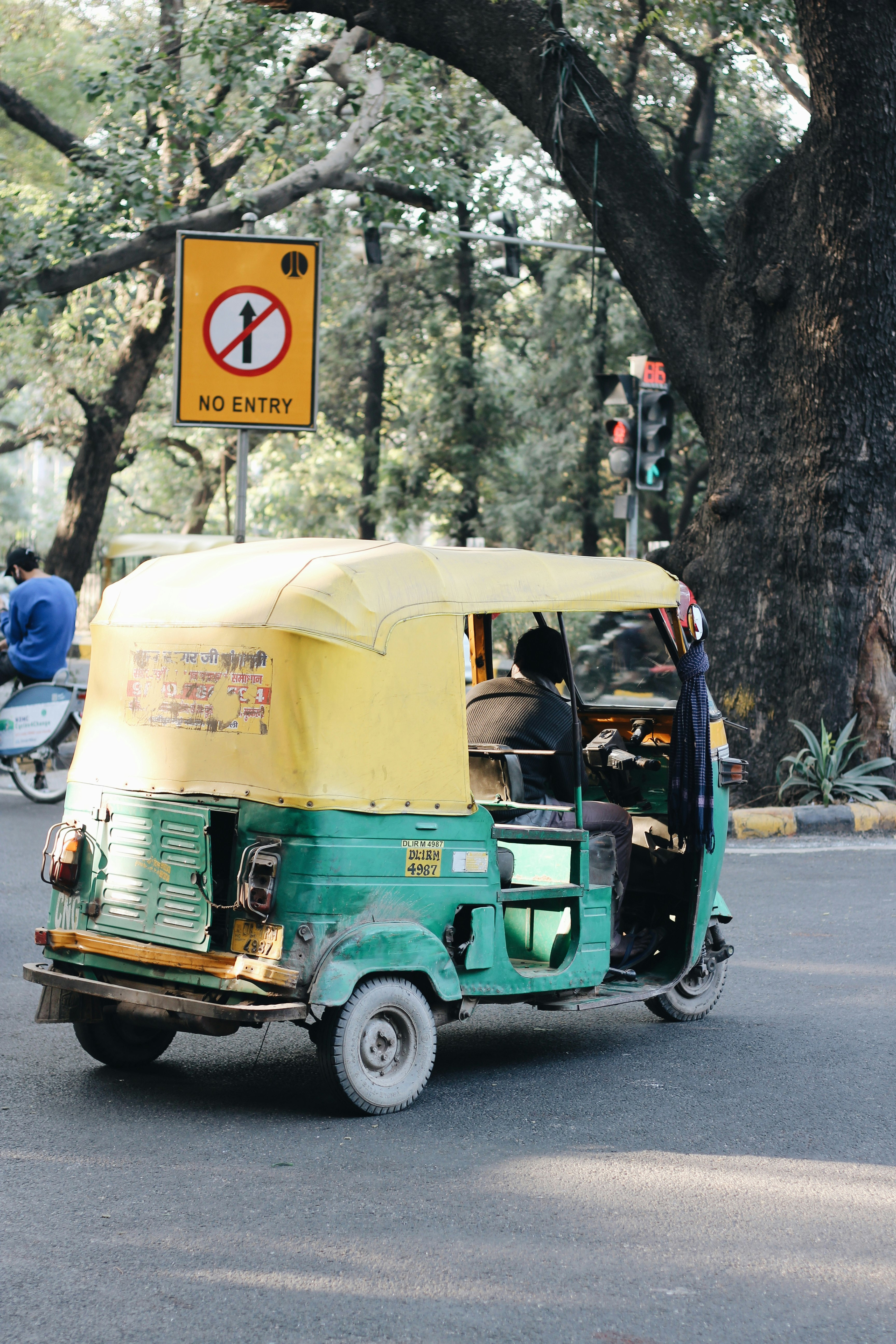 green and white auto rickshaw on road during daytime