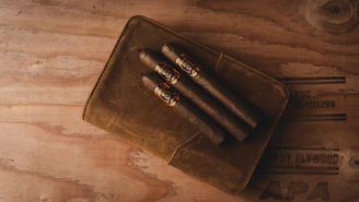 brown leather bifold wallet on brown wooden table