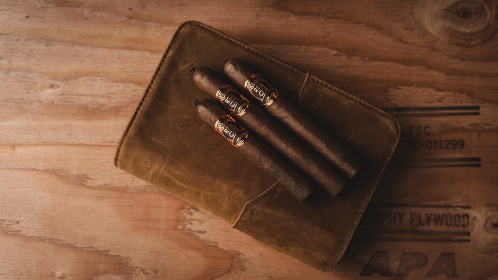 brown leather bifold wallet on brown wooden table