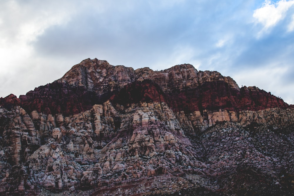 brown rocky mountain under cloudy sky during daytime