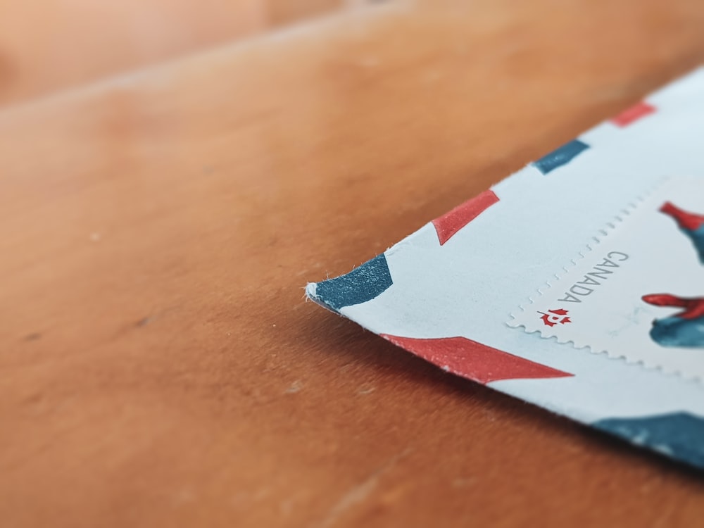 white and red paper on brown wooden table