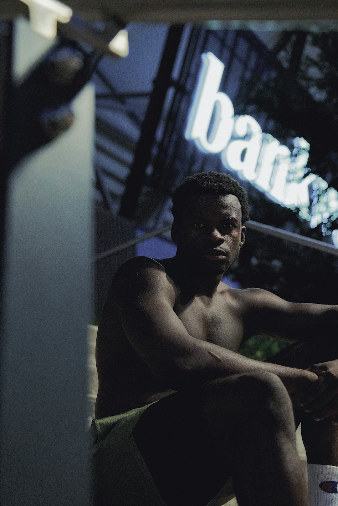 topless man sitting on chair