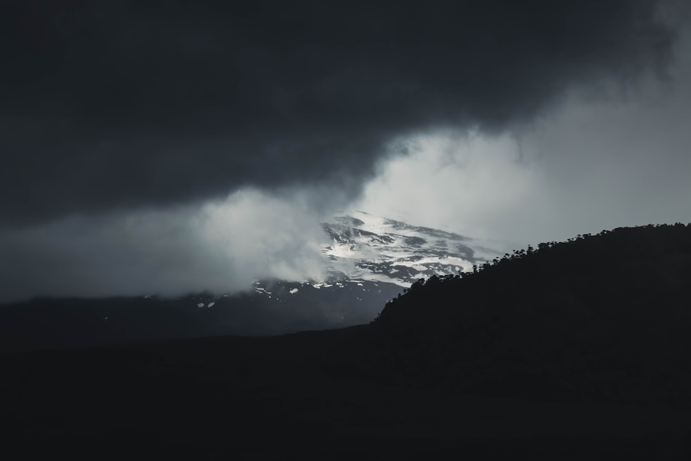 white clouds over mountain during daytime